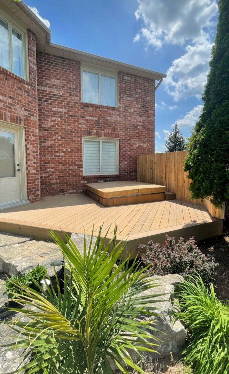 Backyard deck and landing beside a brick home in Georgetown