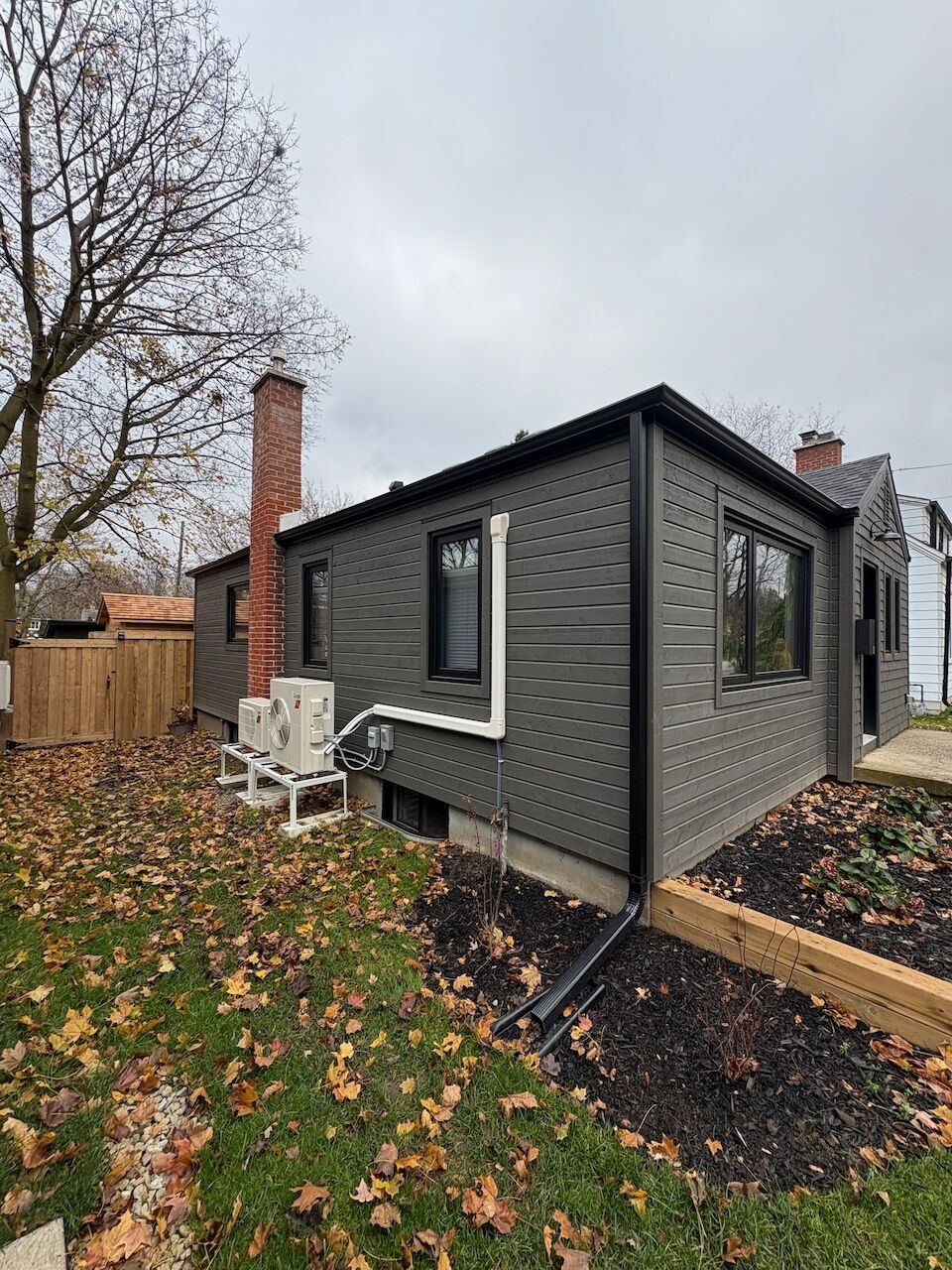 Grey home with new eavestrough and exterior finishes on McCarthy project