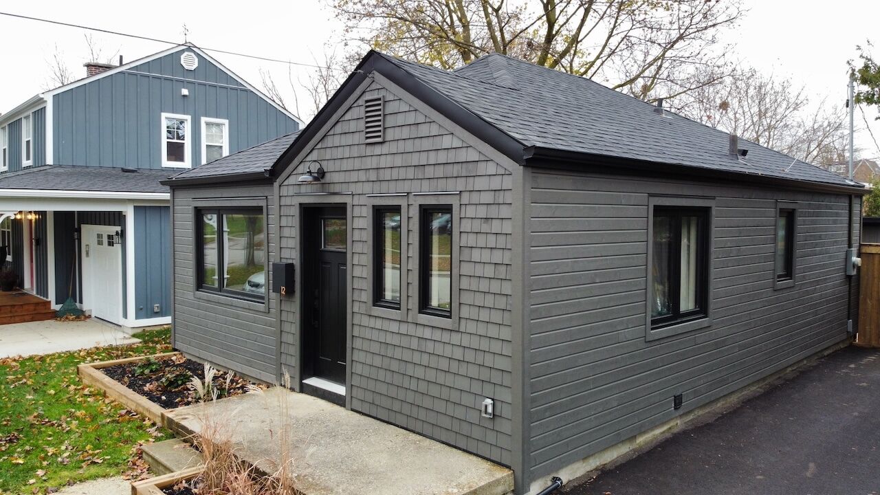 Grey shake-sided bungalow after a full exterior renovation
