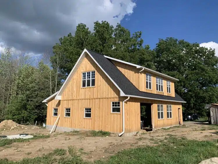 Cedar-sided custom home under construction at The Grange